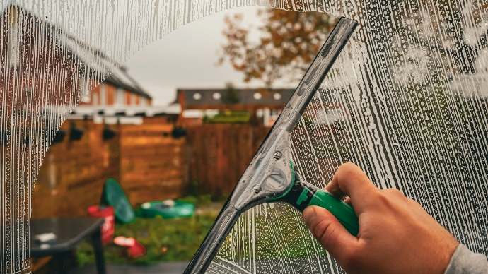 A person is drawing a picture on a window